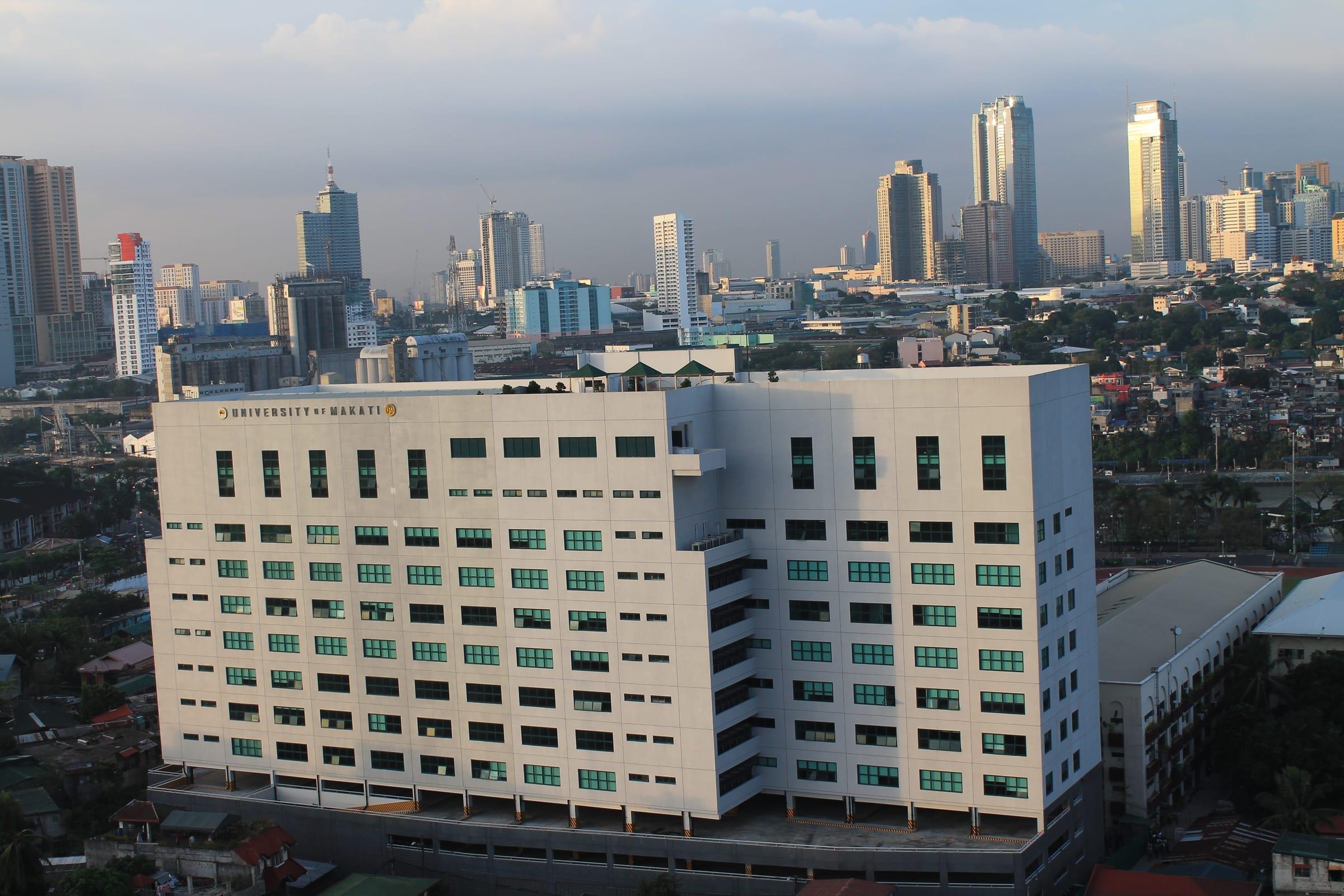 University of Makati main building with the Makati skyline